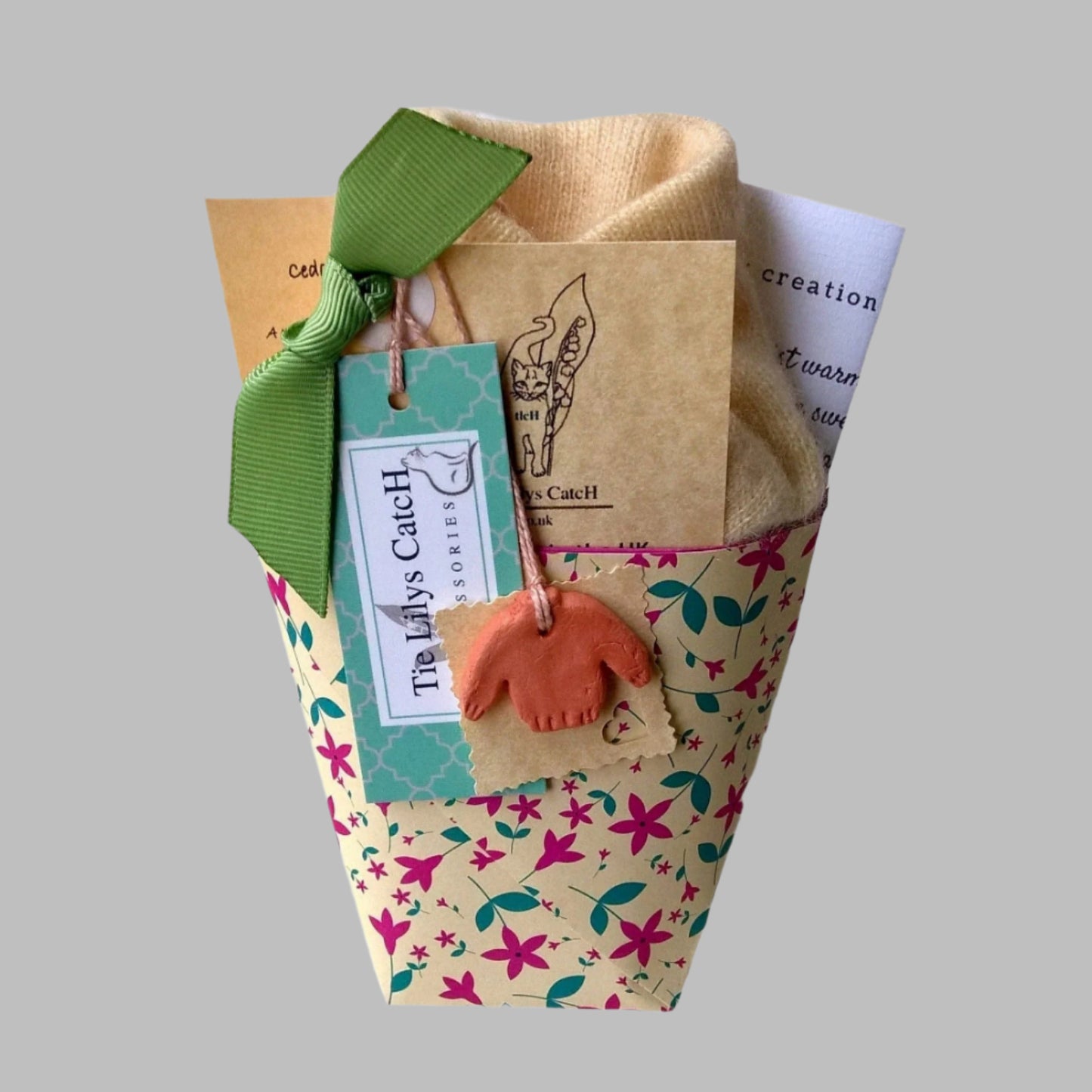 Handmade cashmere wrist warmers packaged in a range of colourful patterned and plain festival paper for gifting