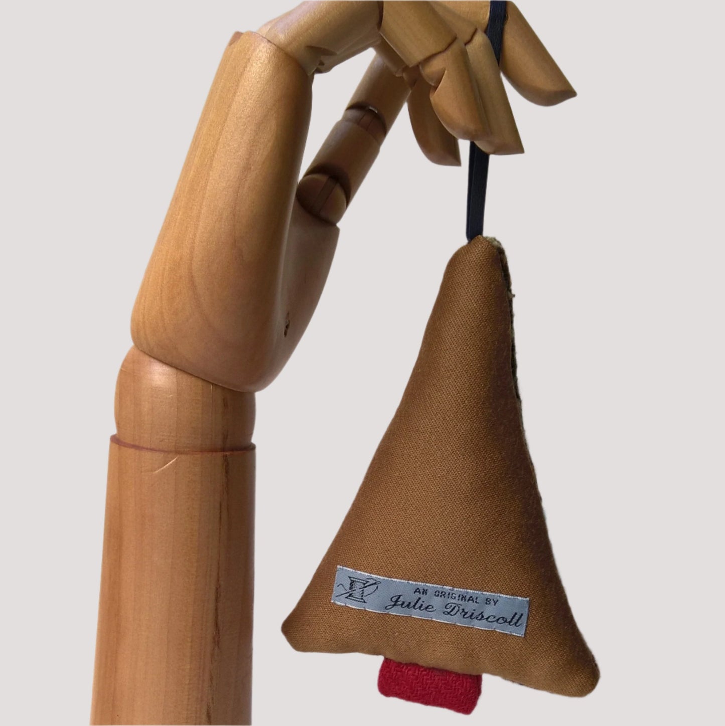 Back of hanging tree ornament is tobacco coloured wool silk mix fabric