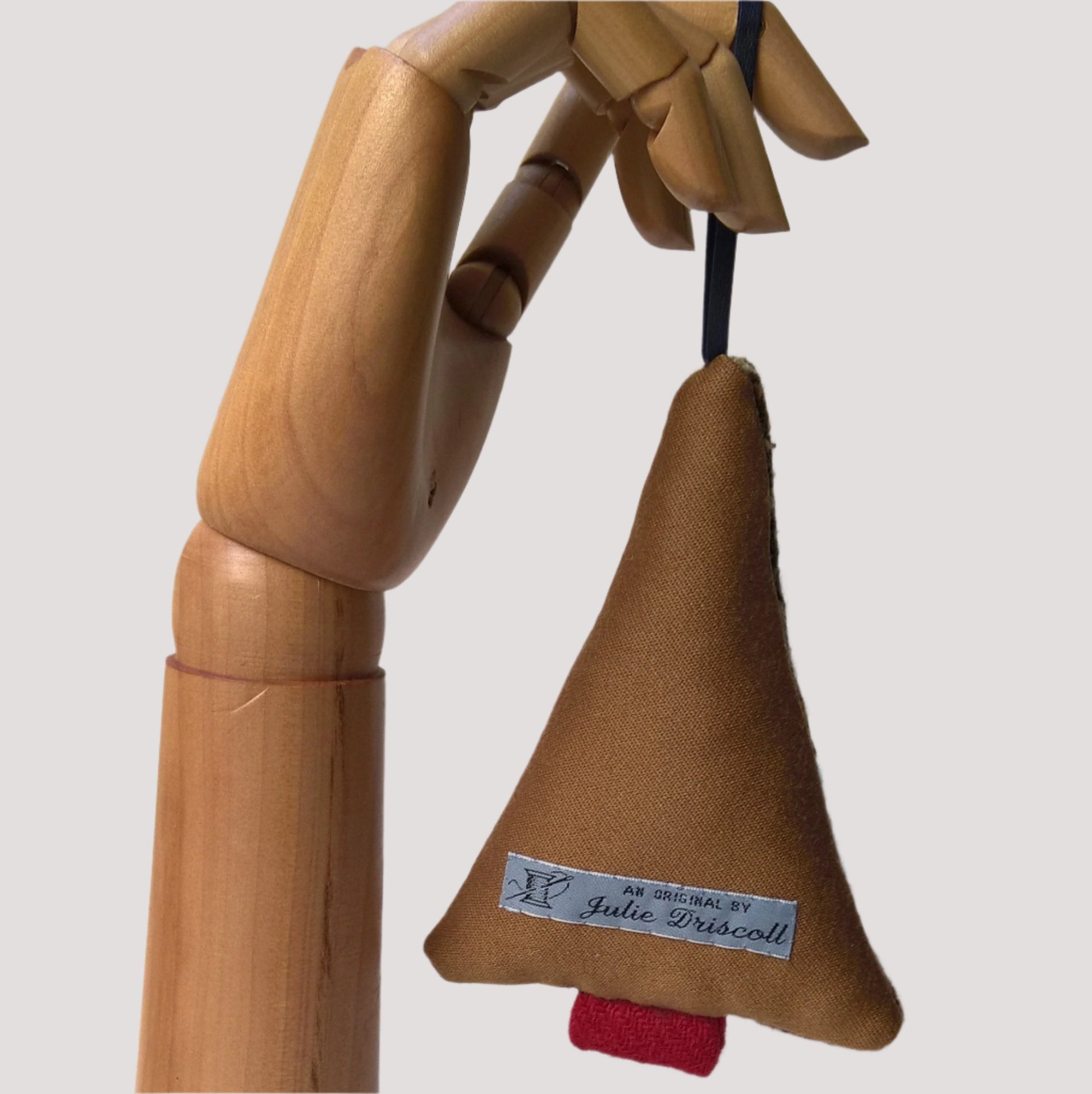 Back of hanging tree ornament is tobacco coloured wool silk mix fabric