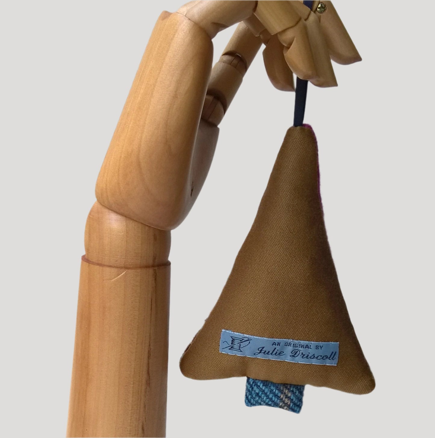 Back of hanging tree ornament is wool silk mix fabric in tobacco brown colour