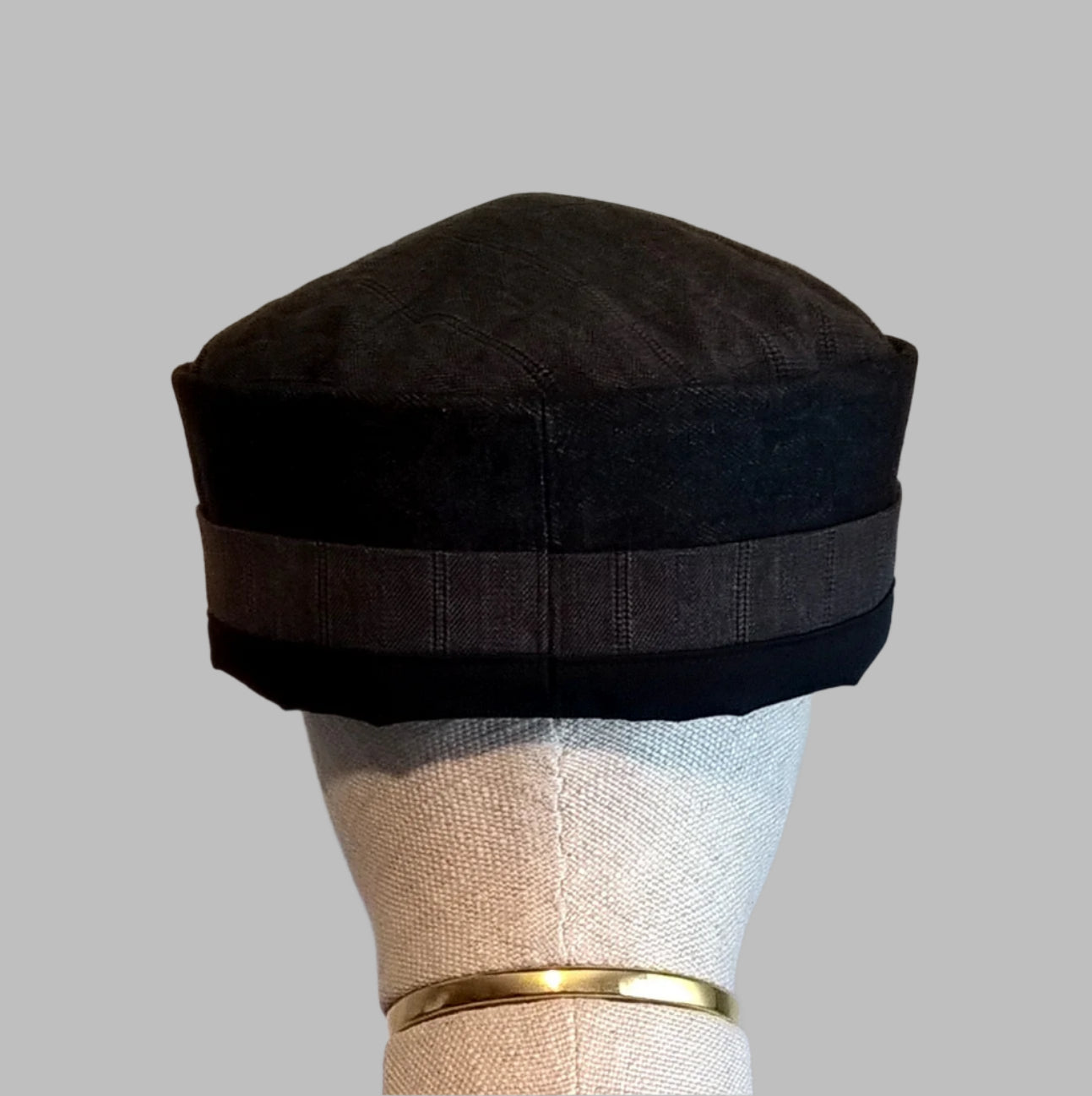 Back view of black brimless cap handmade in breathable fabrics of wool cashmere blend, cotton denim and cotton twill