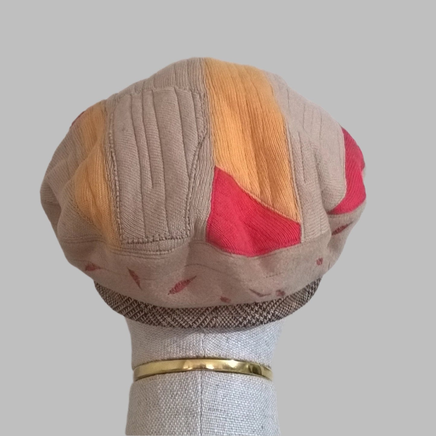Back view of quilted patchwork beret in fawn, red and yellow