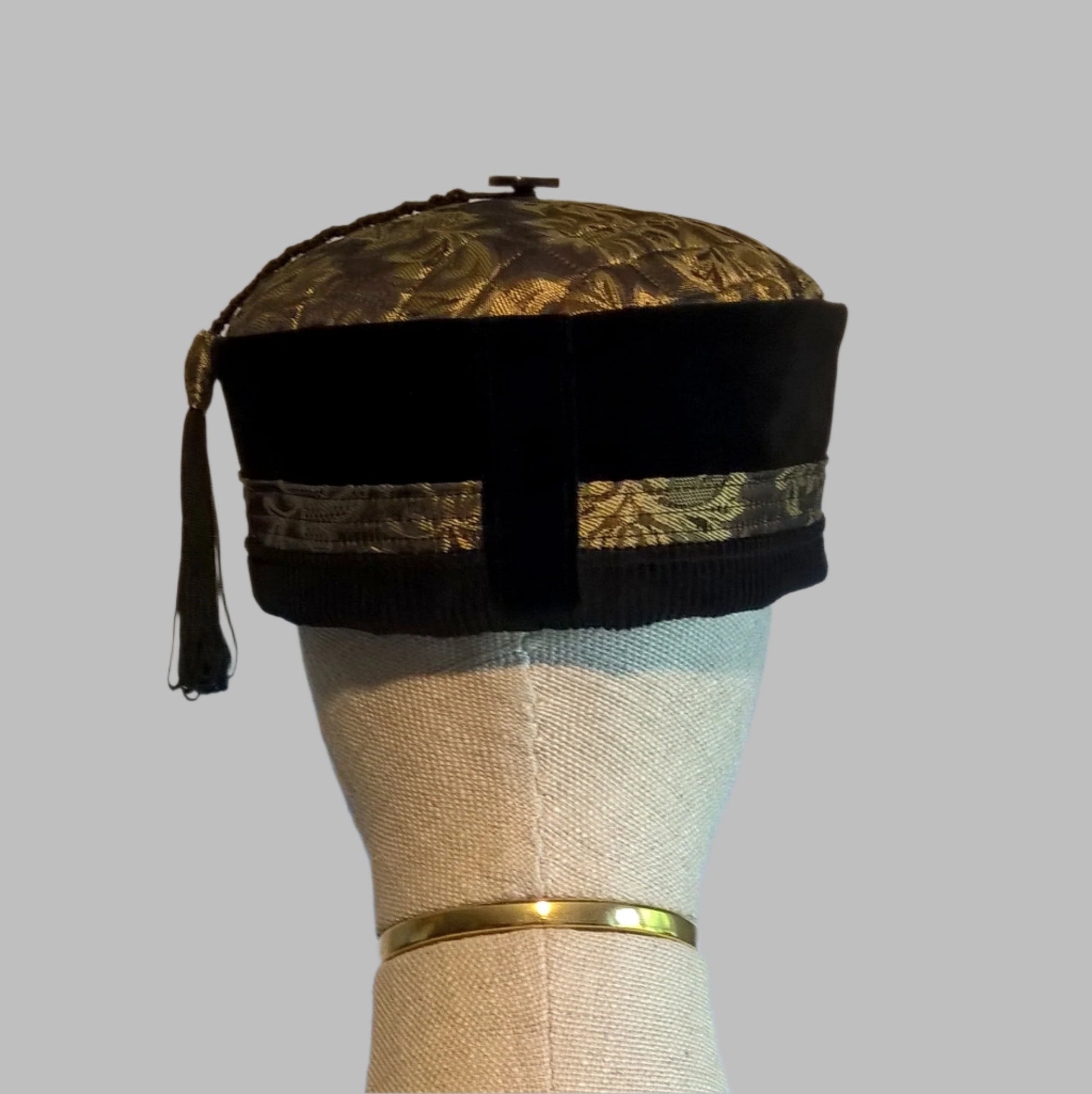 Back view of black velvet and gold brocade tassel smoking cap