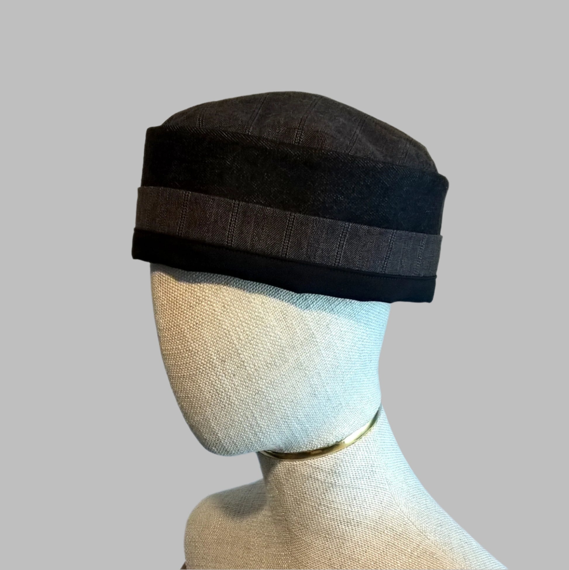 Black brimless cap handmade in breathable wool, cashmere, denim and cotton fabrics with lightly quilted tip for warmer weather