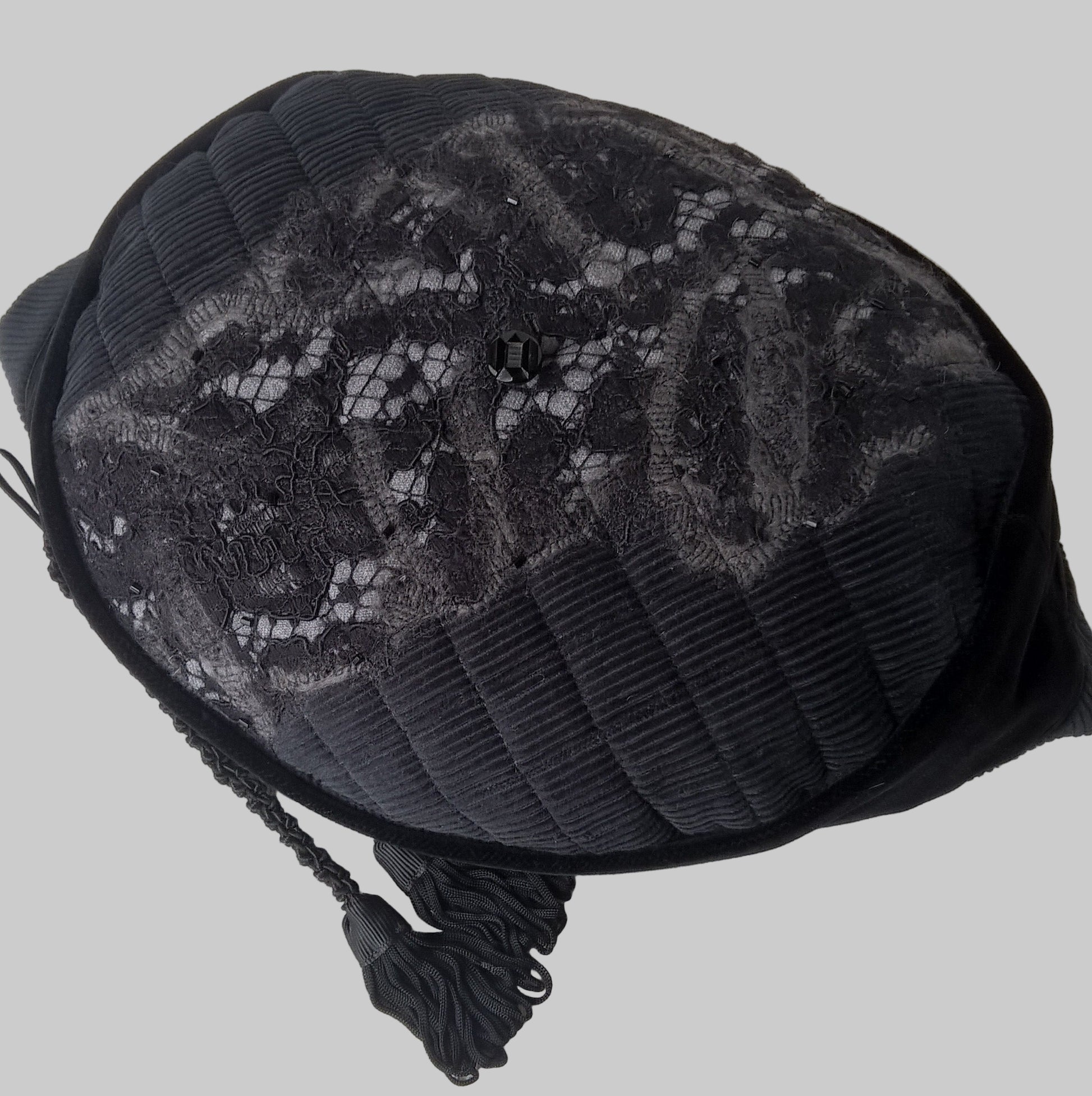 The black felted hat has a removable tassel