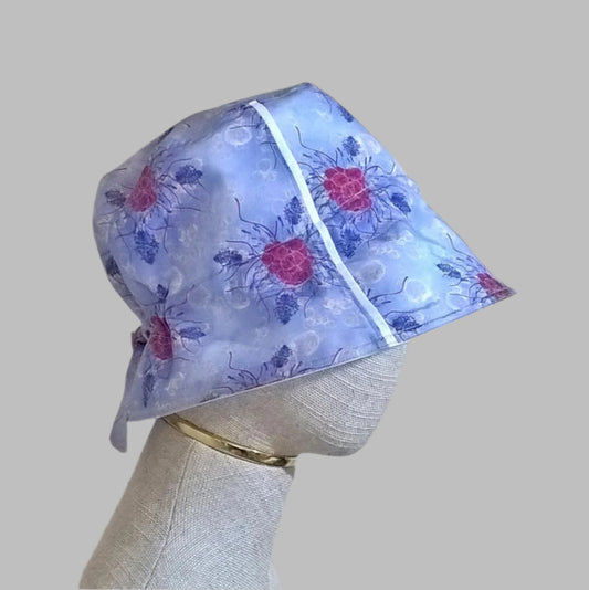 Cotton silk bucket hat with raspberries and lavender on a blue background, and adjustable tie back