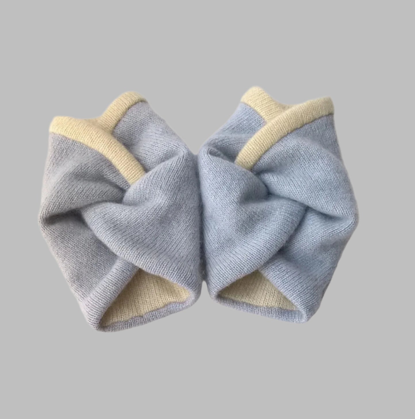 Cashmere wrist warmers handmade from up-cycled sweaters in pale blue and cream.