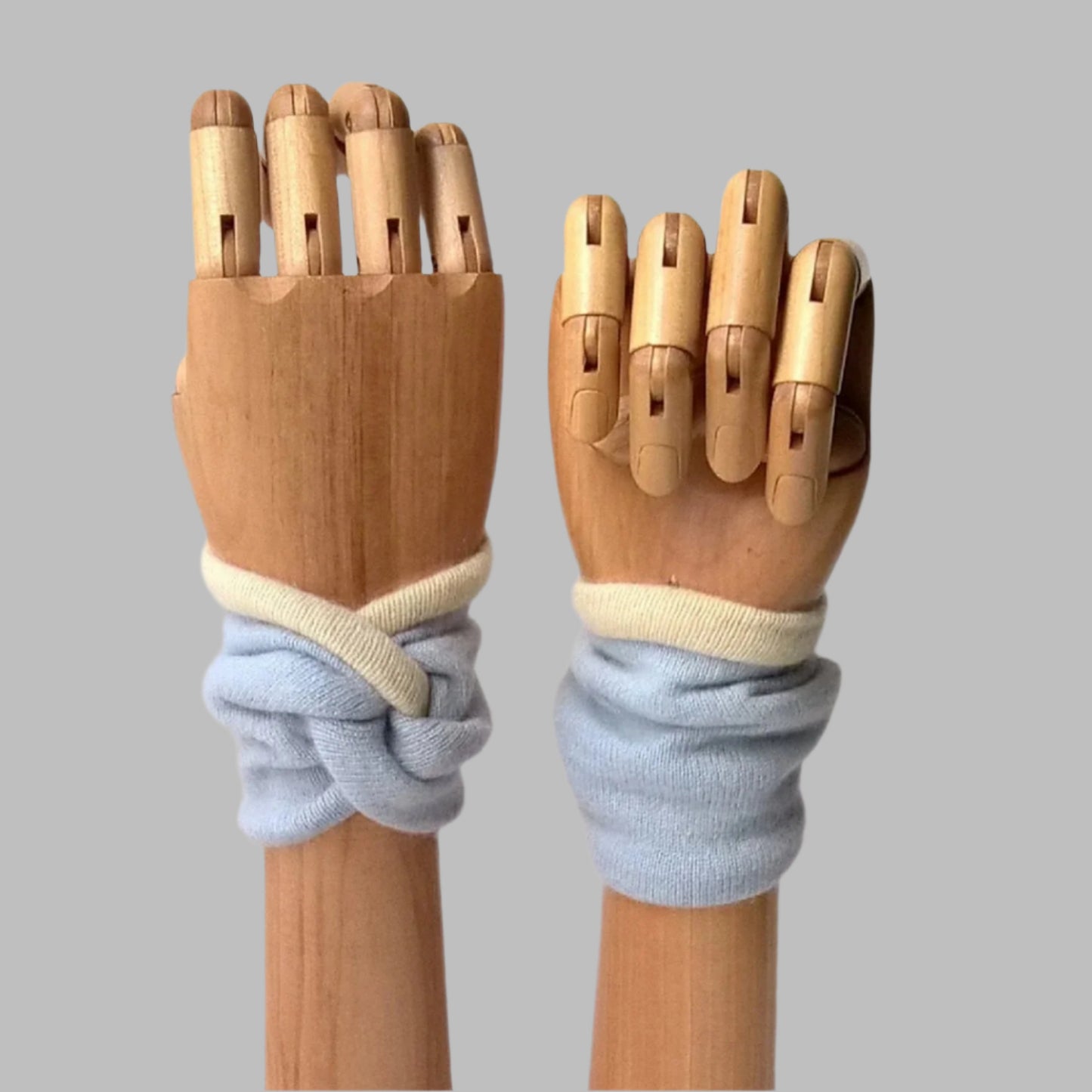 Pure Cashmere wrist warmer cuffs handmade in pale blue with cream edging and lining.
