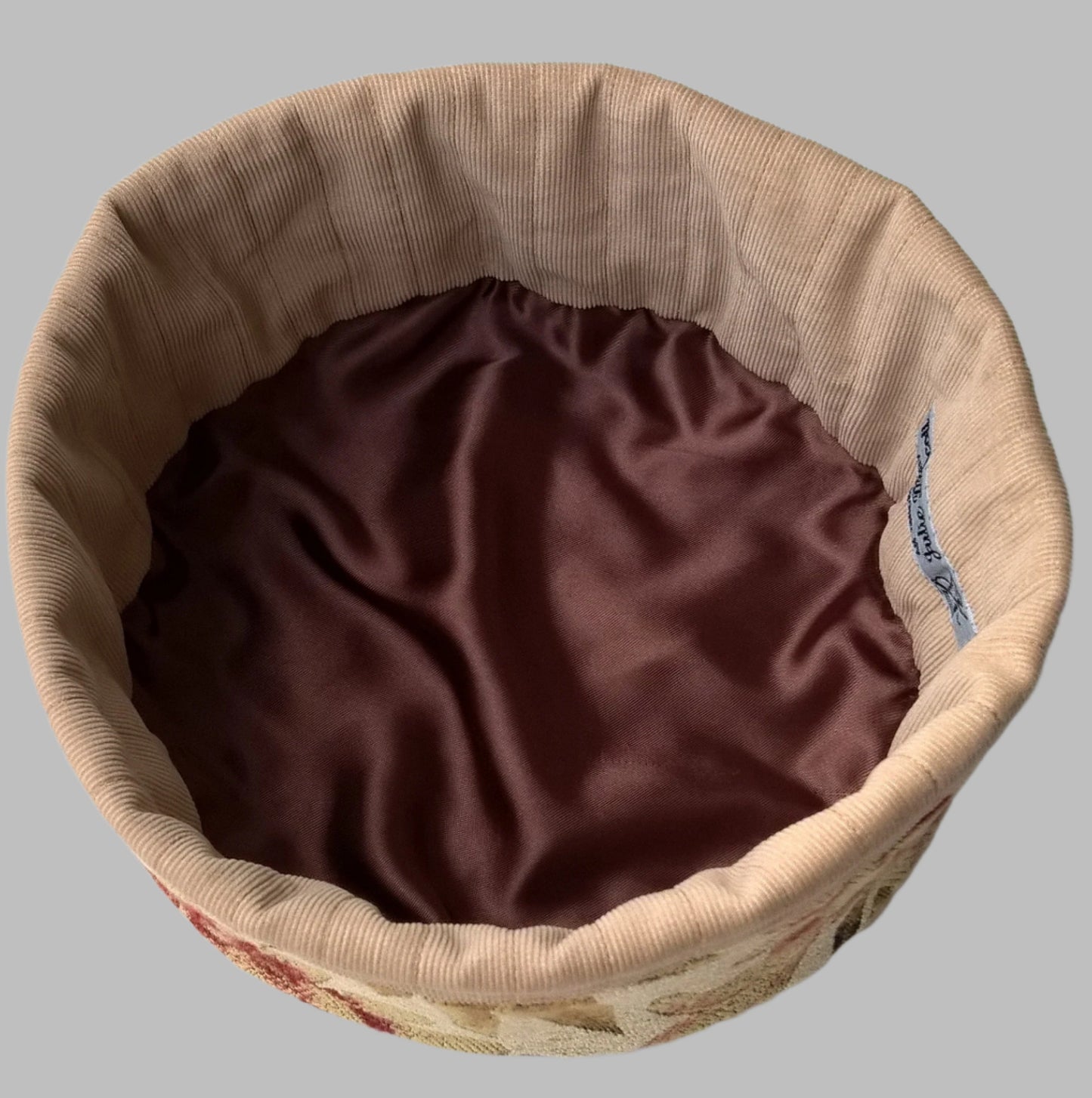 Quilted corduroy and satin form the lining of the tapestry smoking cap