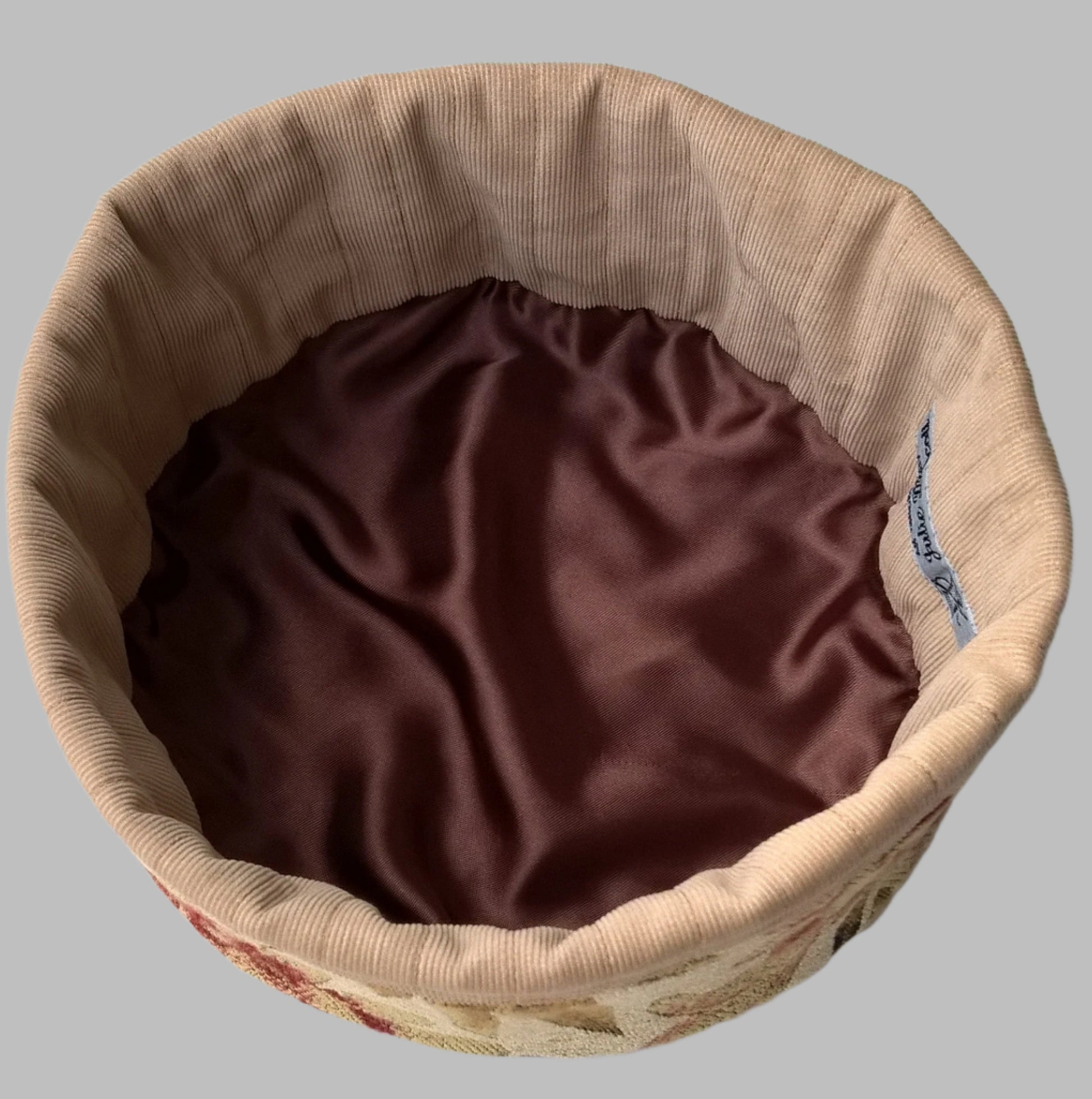Quilted corduroy and satin form the lining of the tapestry smoking cap