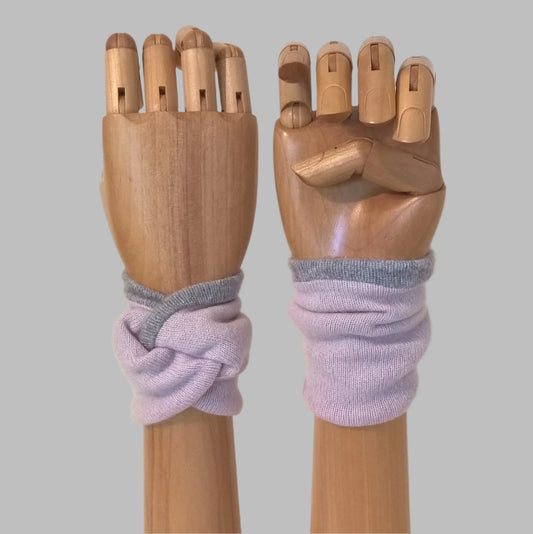 Dusky pink pure cashmere wrist warmer cuffs, handmade in a knot design, edged and lined with pale grey cashmere