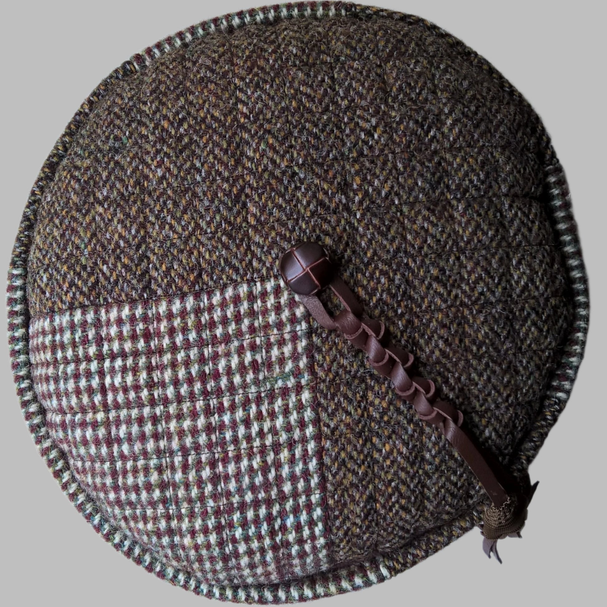 Patchwork design on tip of Harris Tweed hat, with vintage jacket button and macrame leather tassel