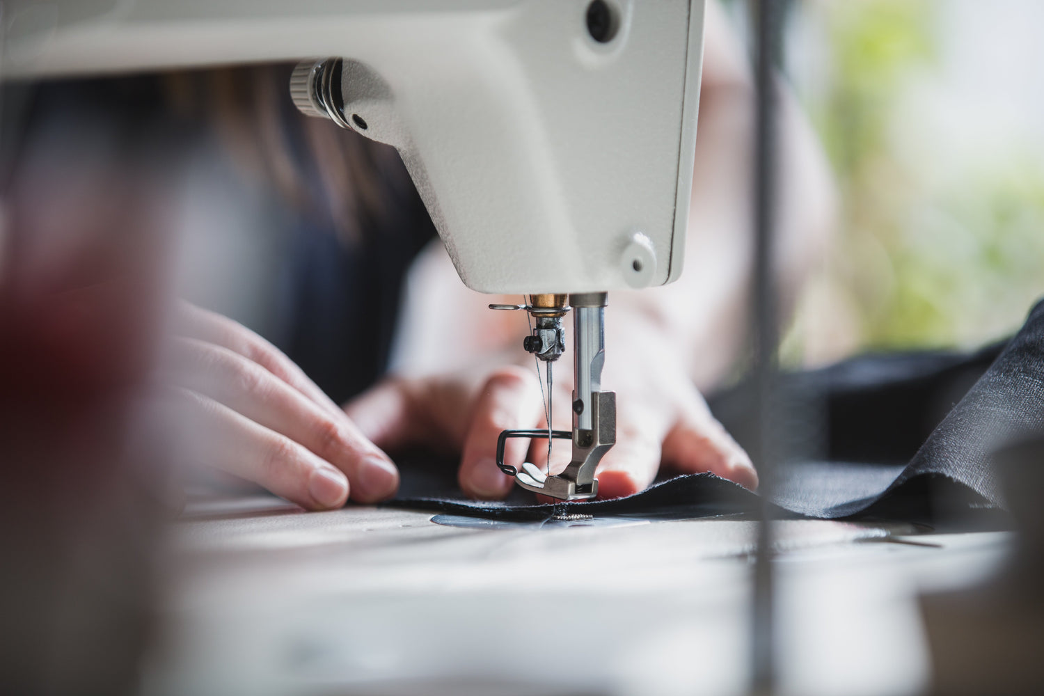 Fabric pieces being stitched on a sewing machine