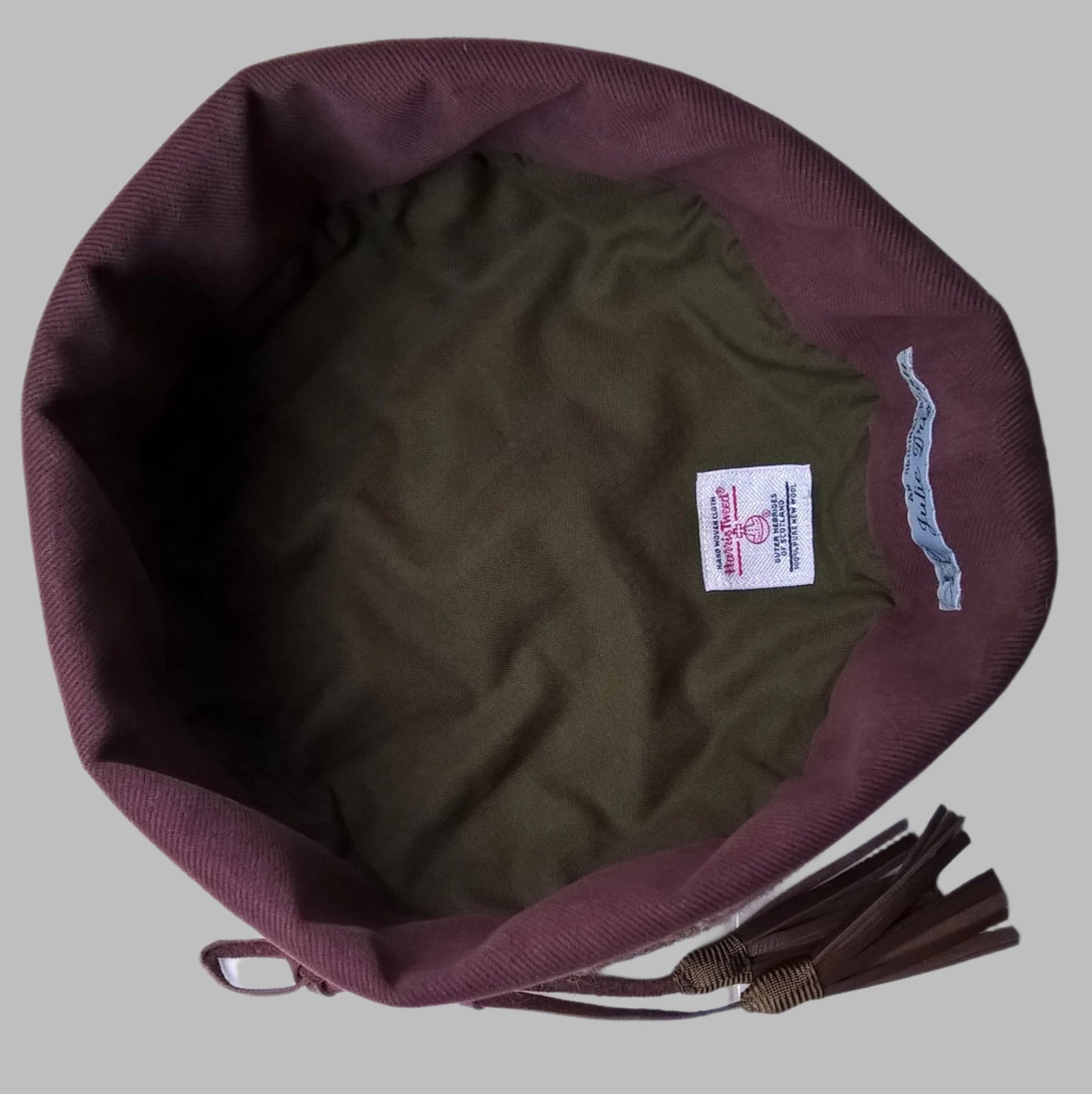 Harris tweed hat is lined in green cotton