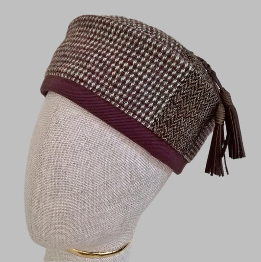 Harris Tweed wool smoking cap, in browns, cream and mauve shades, with leather tassel 