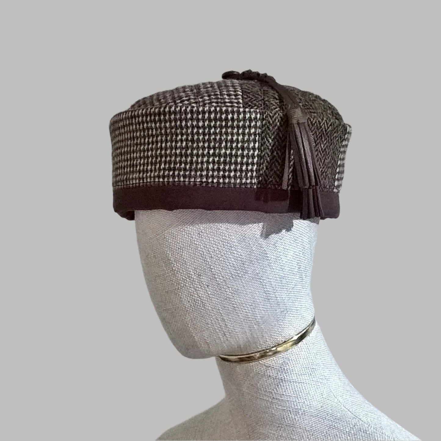 Harris tweed smoking cap in a mismatched patchwork design with leather tassel