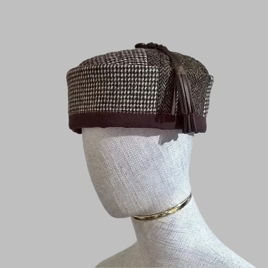 Harris tweed smoking cap in a mismatched patchwork design with leather tassel
