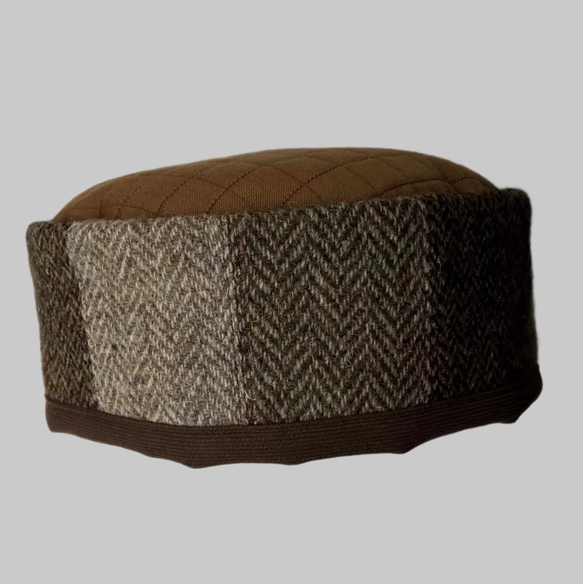 Three different herringbone Harris Tweeds form the crown of the hat edged with dark chocolate coloured cotton 