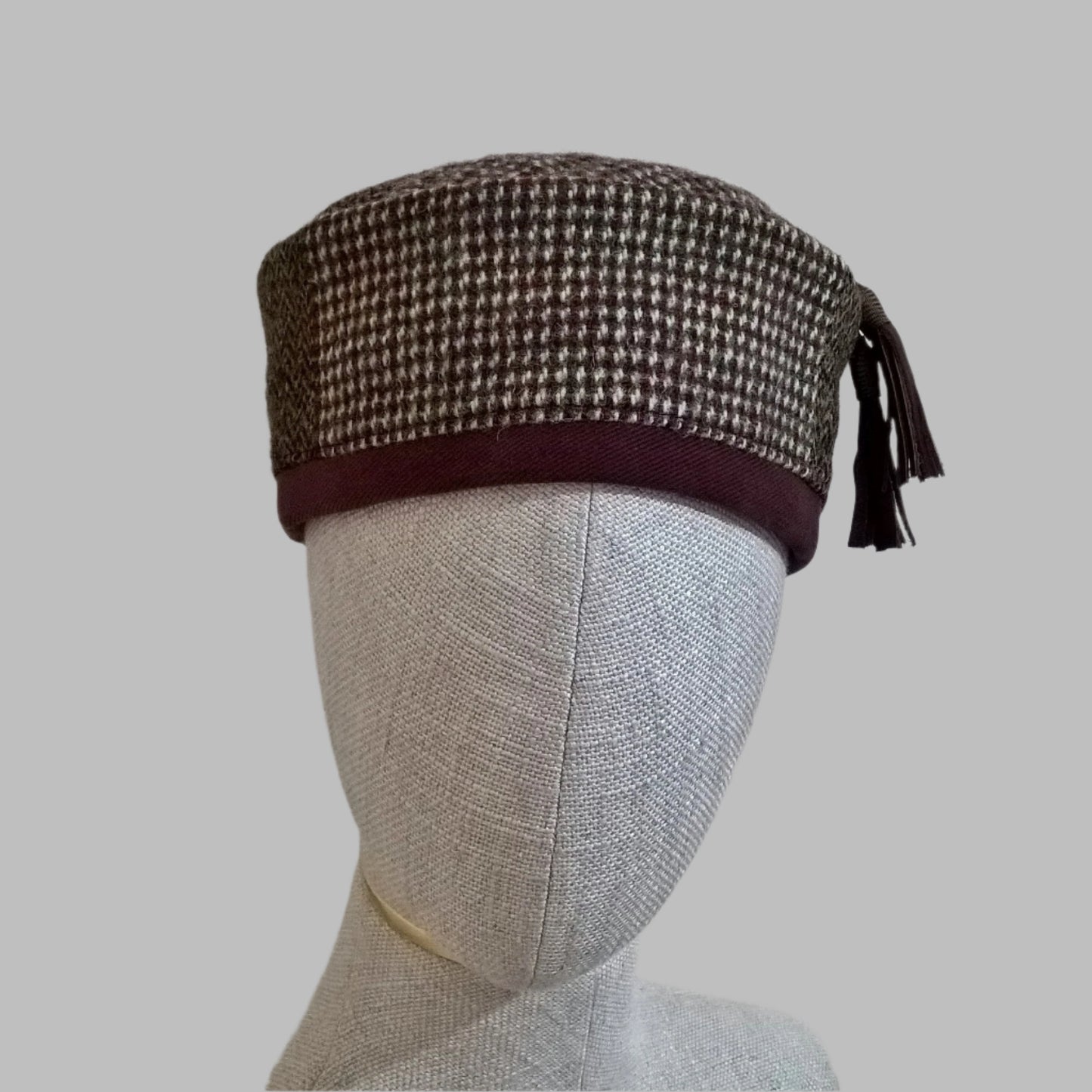Harris Tweed wool smoking cap, in browns, cream and mauve shades, with macrame leather tassel