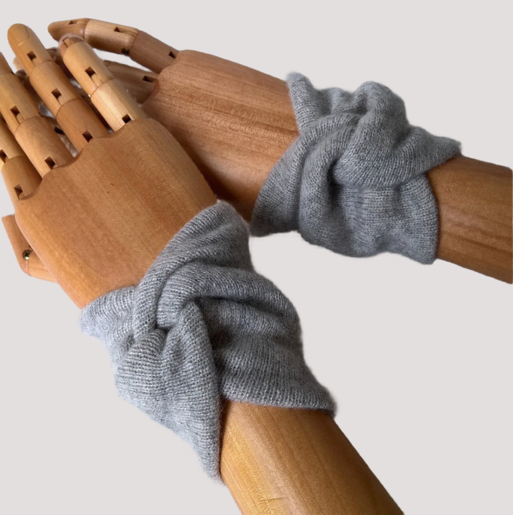 A pair of handmade light grey marl upcycled cashmere wrist warmers