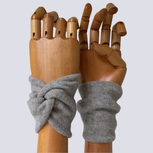 Light gray cashmere wrist warmers in a snug knot design