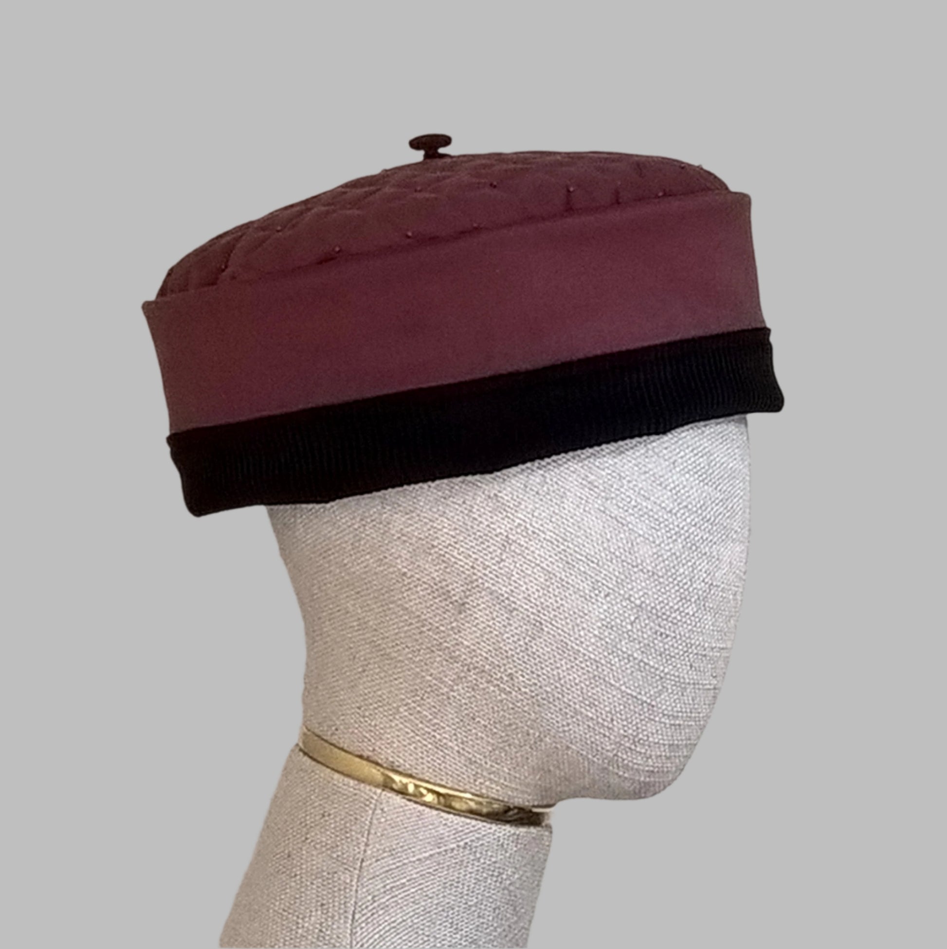 The pillbox shaped hat has a removable tassel