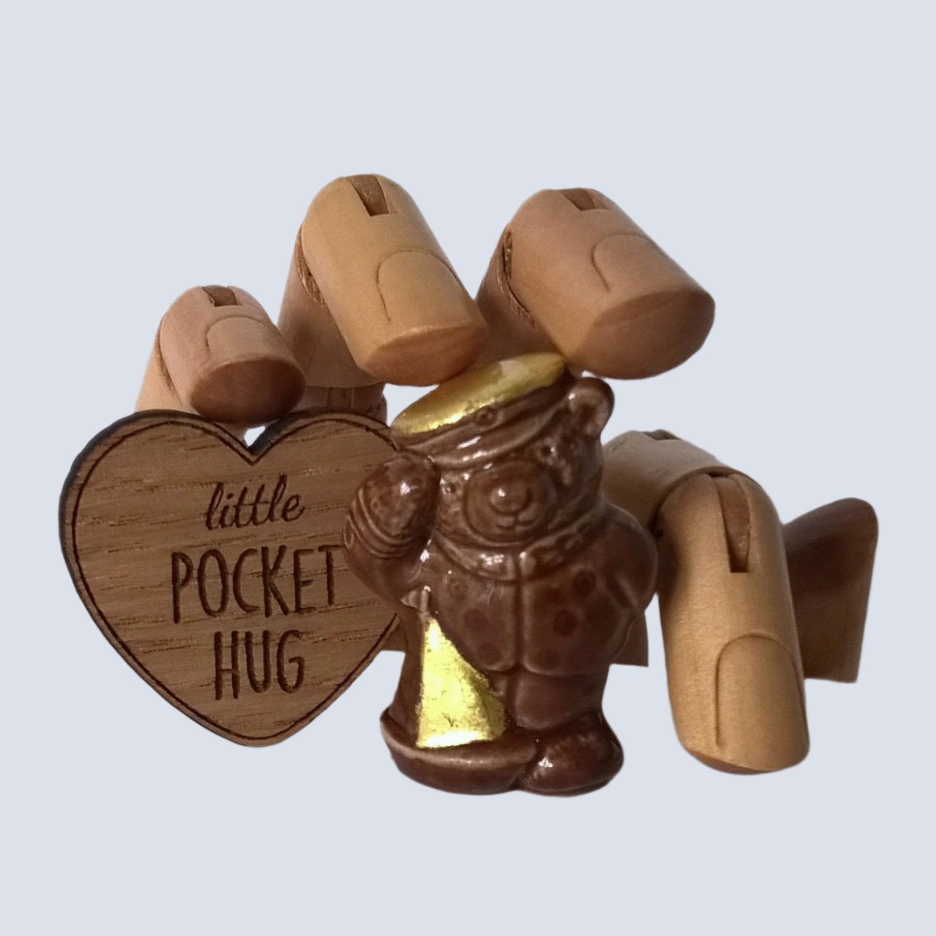 Little brown ceramic sailor bear with wooden heart pocket hug . Pure gold leaf has been added to the bears cap and sail of boat