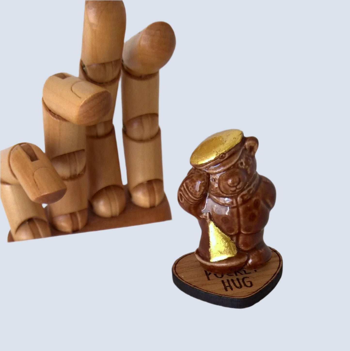 Little ceramic bear comes with a wooden heart pocket hug that doubles as a stand for the bear