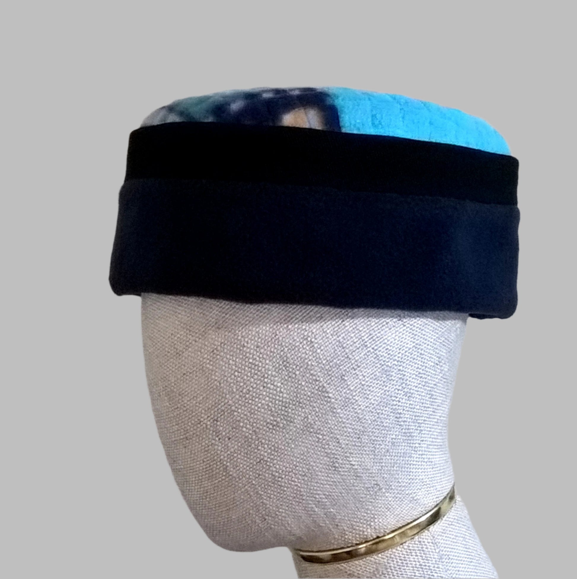 Navy and turquoise pillbox fleece cap with multi coloured patchwork tip