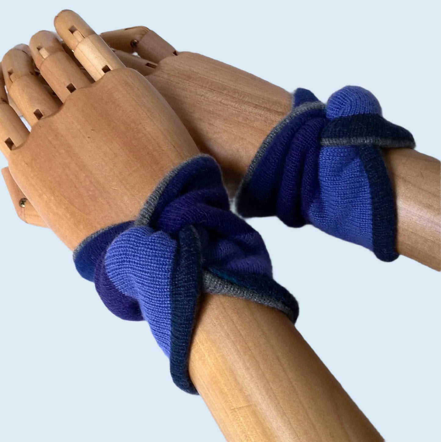 The knot design wrist warmers cover the pulse point to raise body temperature while keeping hands free to do tasks
