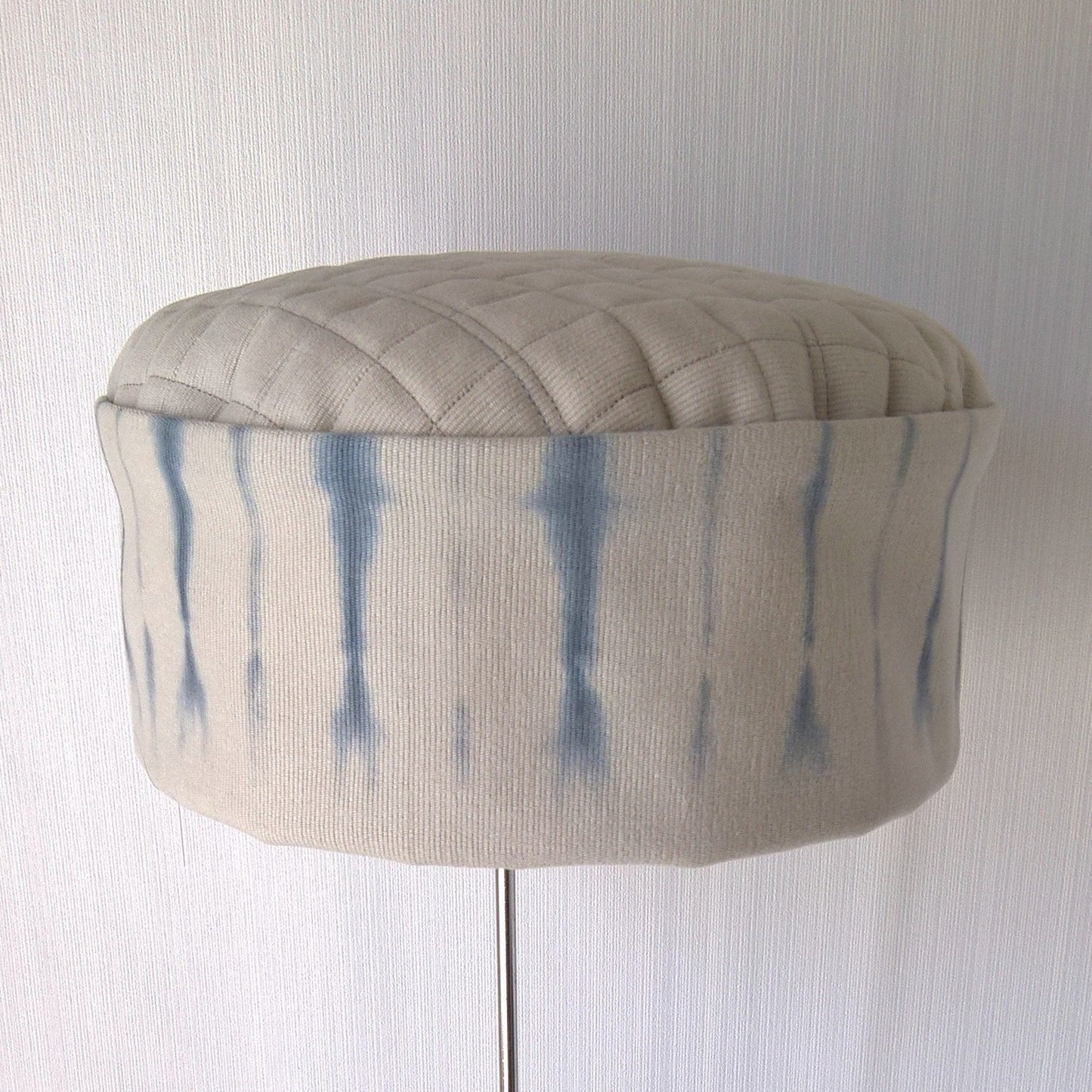 Front view of putty bedfore cord and blue tie dye hat