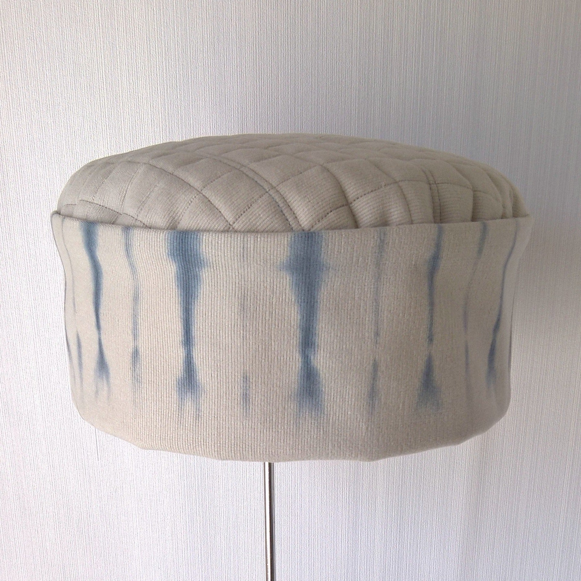 Front view of putty bedfore cord and blue tie dye hat