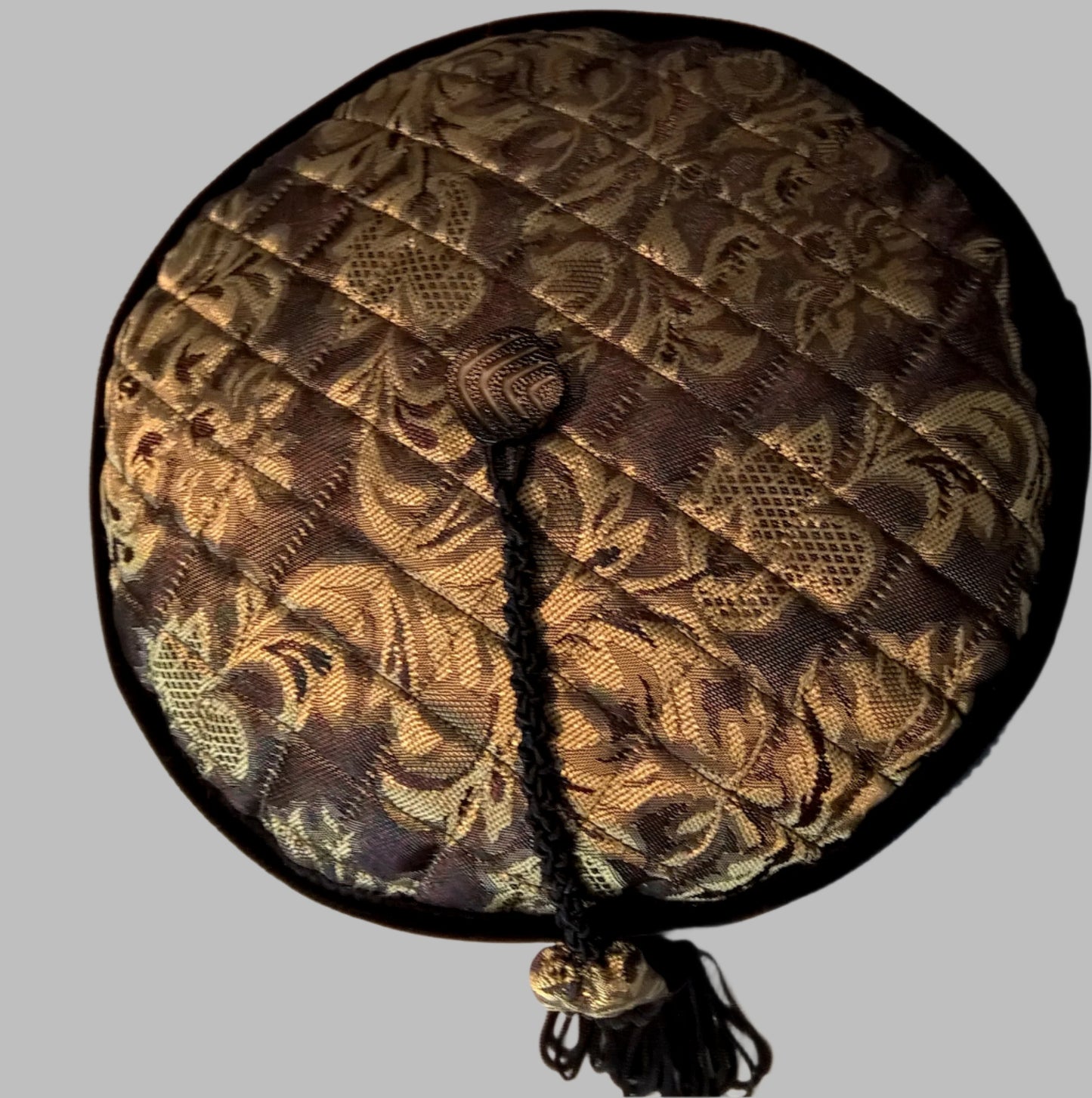 Gold brocade tip of hat is quilted and has a vintage button to attach the removable tassel