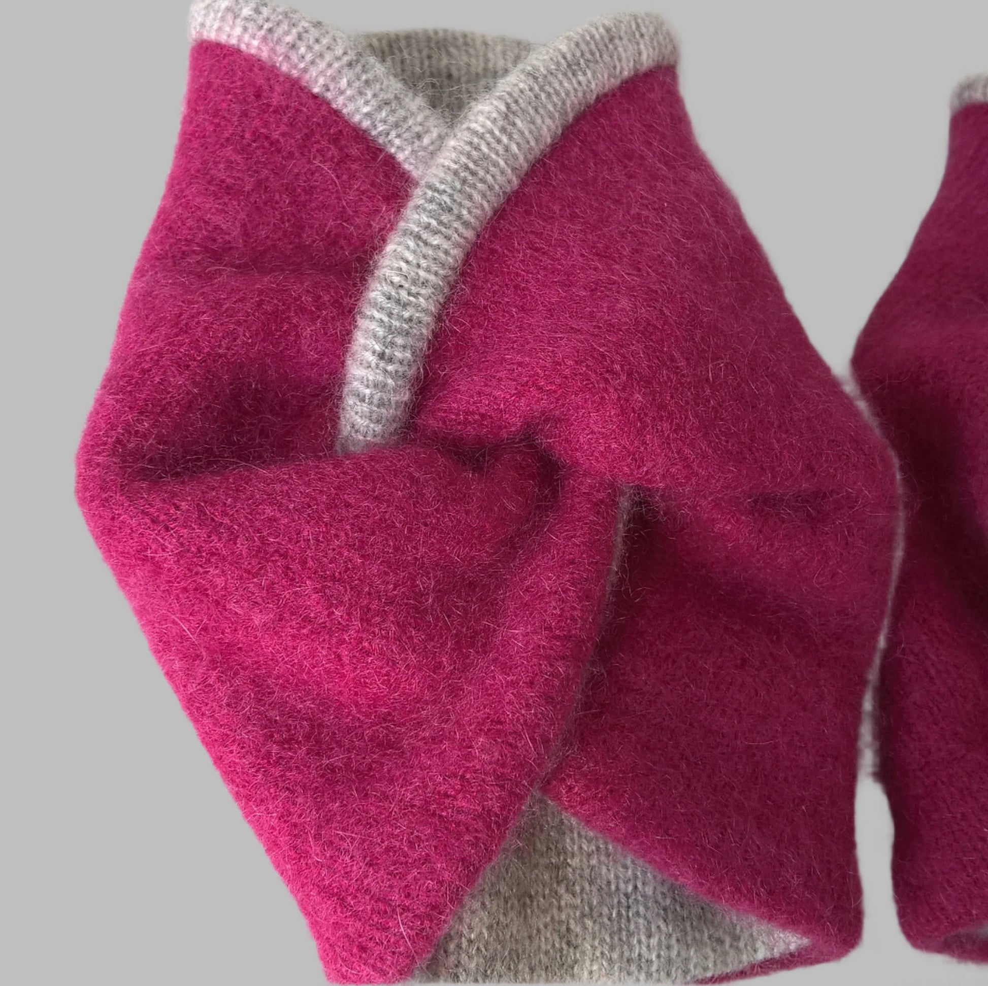 The upcycled raspberry pink cashmere is felted and lined with a fine knitted grey cashmere