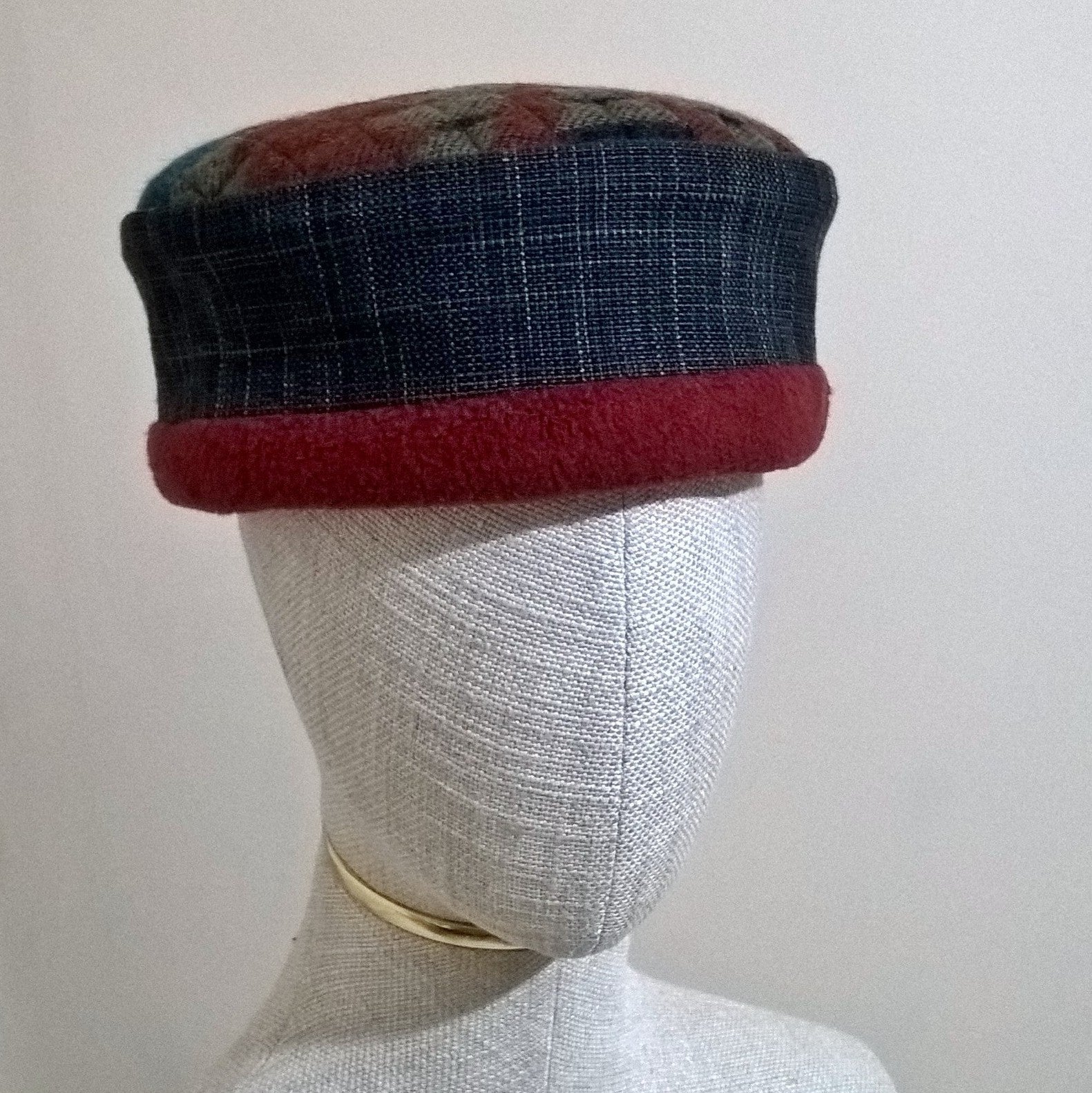 Aztec patterned brimless hat with raspberry red fleece trim and lining