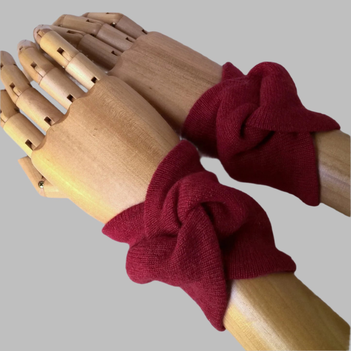 Ruby red wrist warmers cover pulse points to raise body temperature whilst leaving hands free for everyday tasks