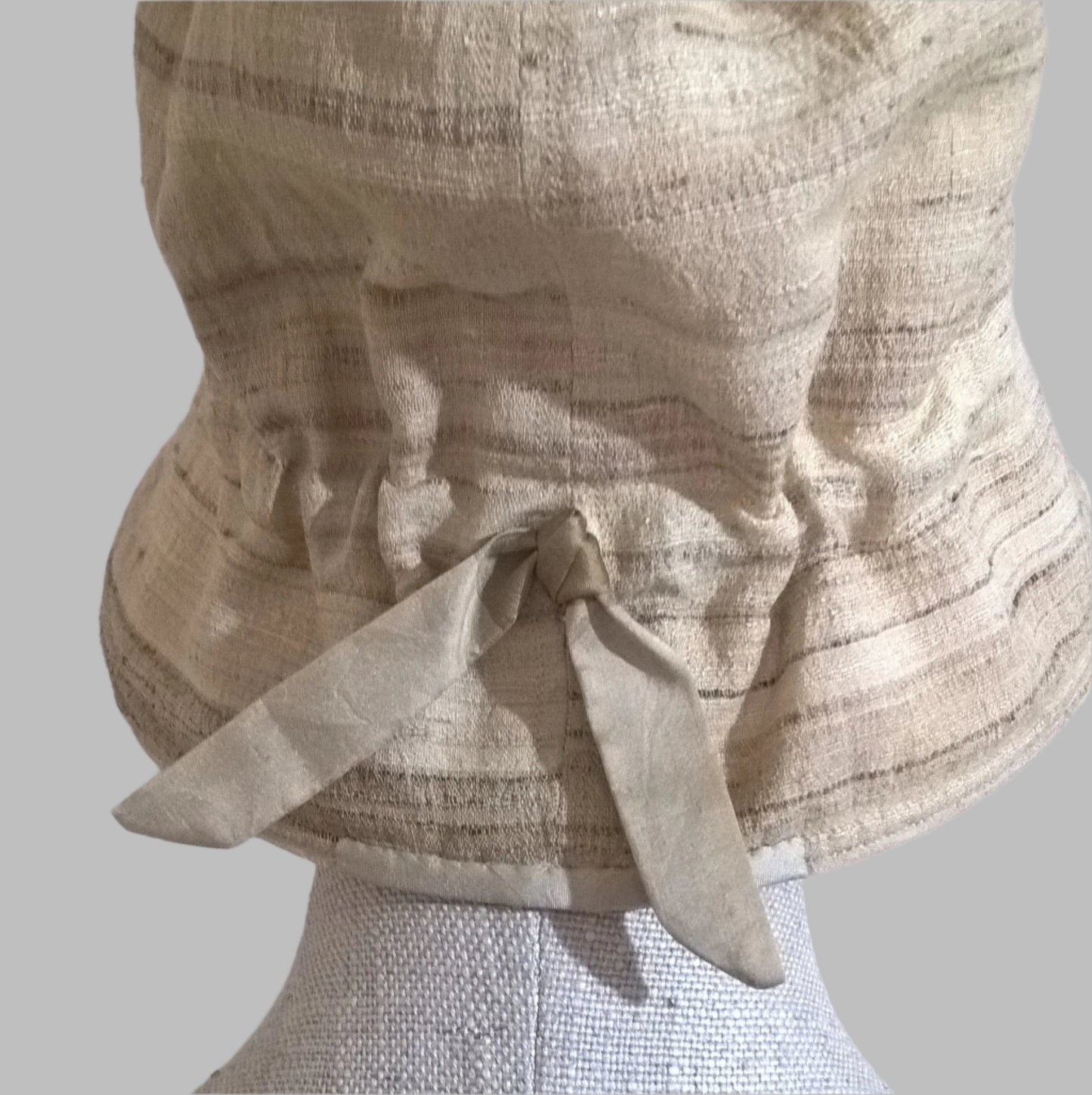Back view of silk bucket hat and adjustable tie detail