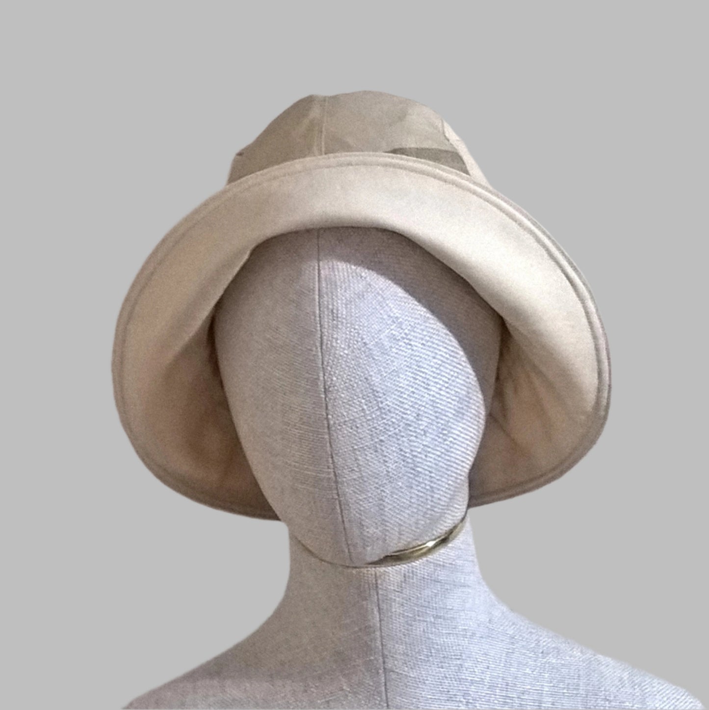 The millinery reed in the brim allows the raw silk bucket hat to be worn various ways, such as with the brim front turned up 