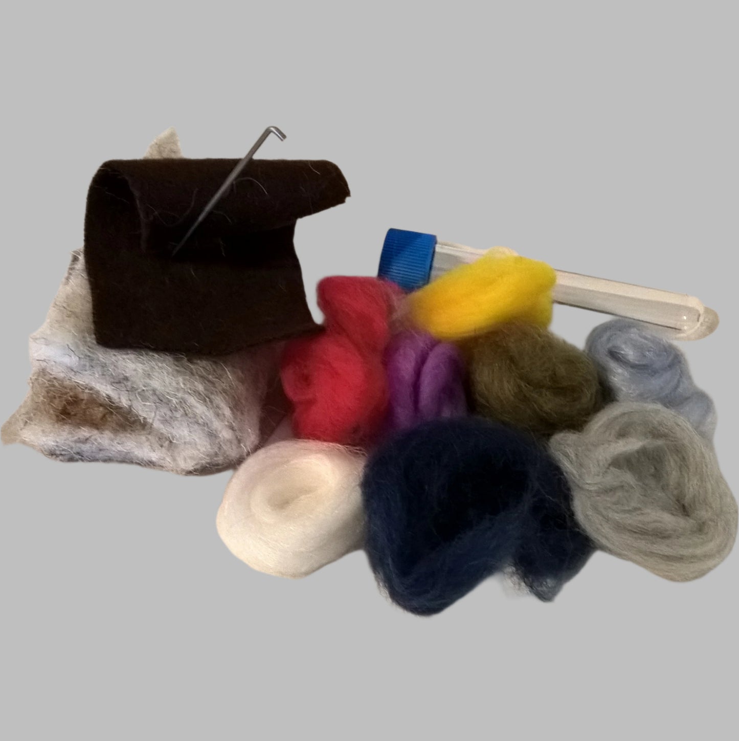 Small selection of needle felting supplies, including mat, wool and needles