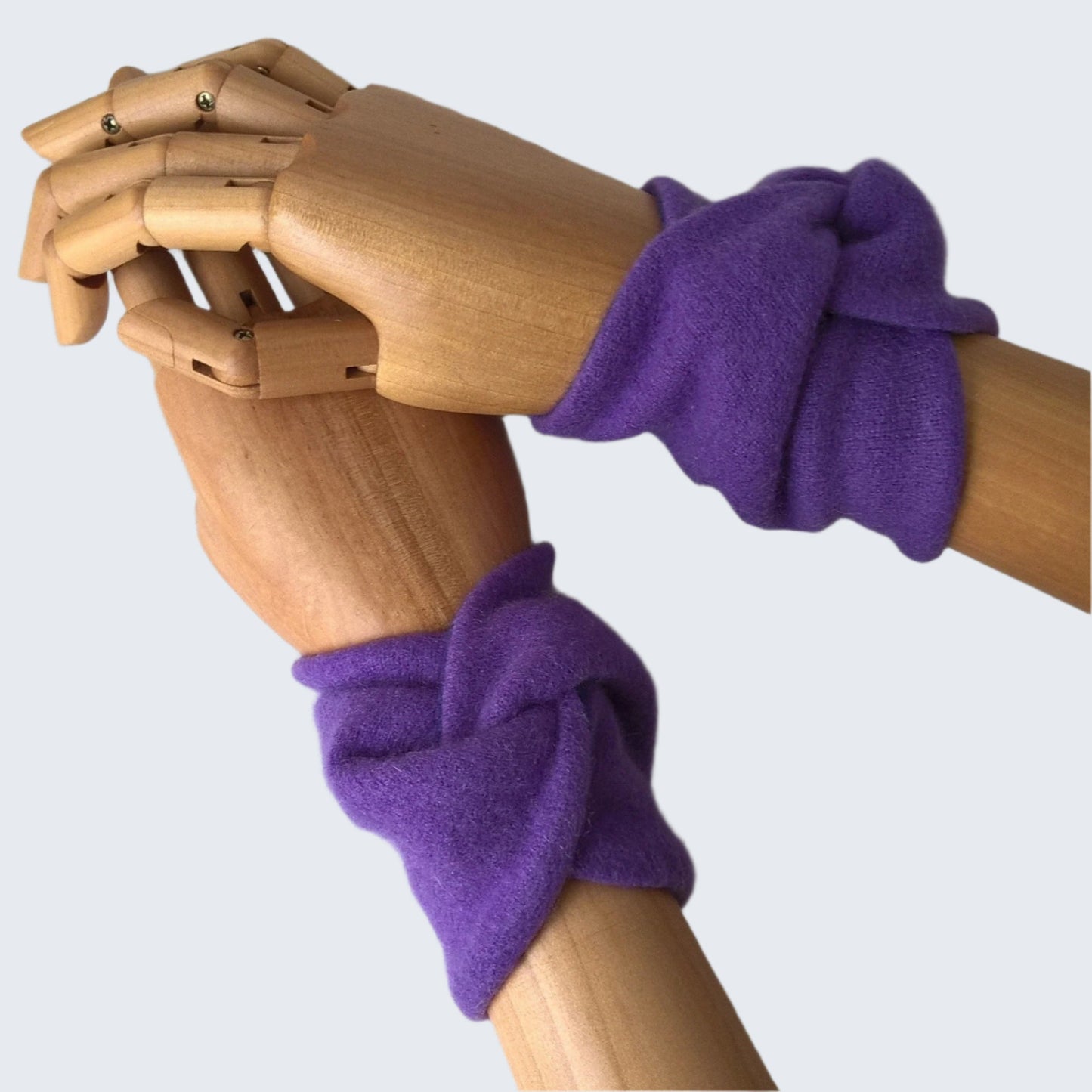 A pair of violet coloured felted cashmere wrist warmers