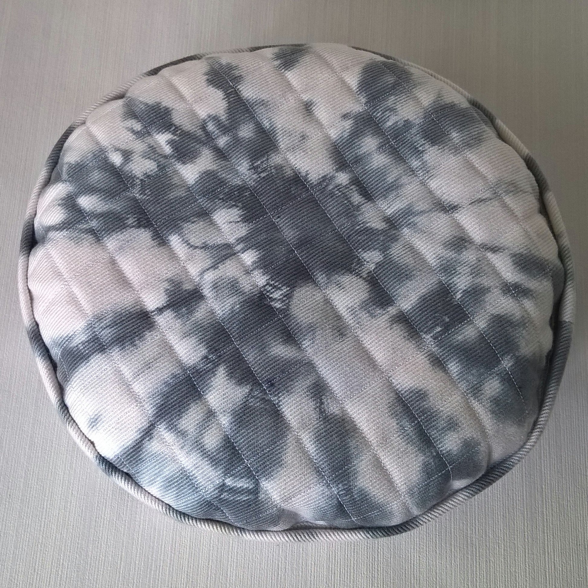 Showing the tip of white cotton twill cap with black  shibori tie dye